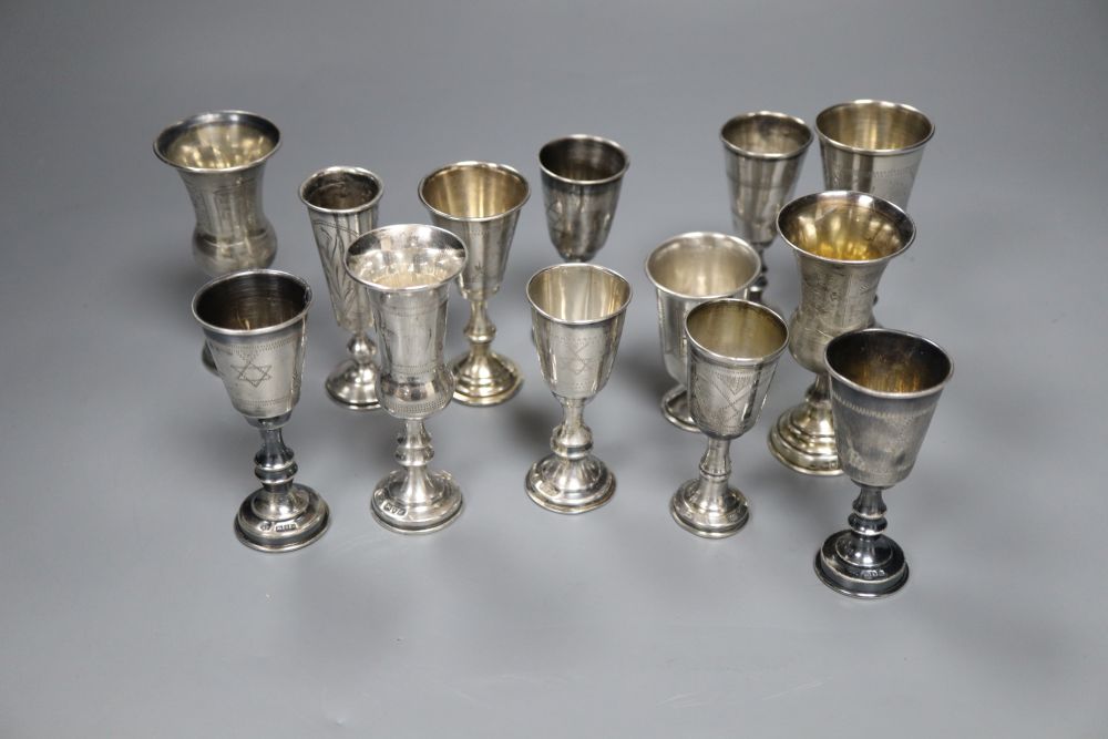 Eleven assorted mainly early 20th century silver kiddush cups and two similar Russian cups, gross 11.25oz.